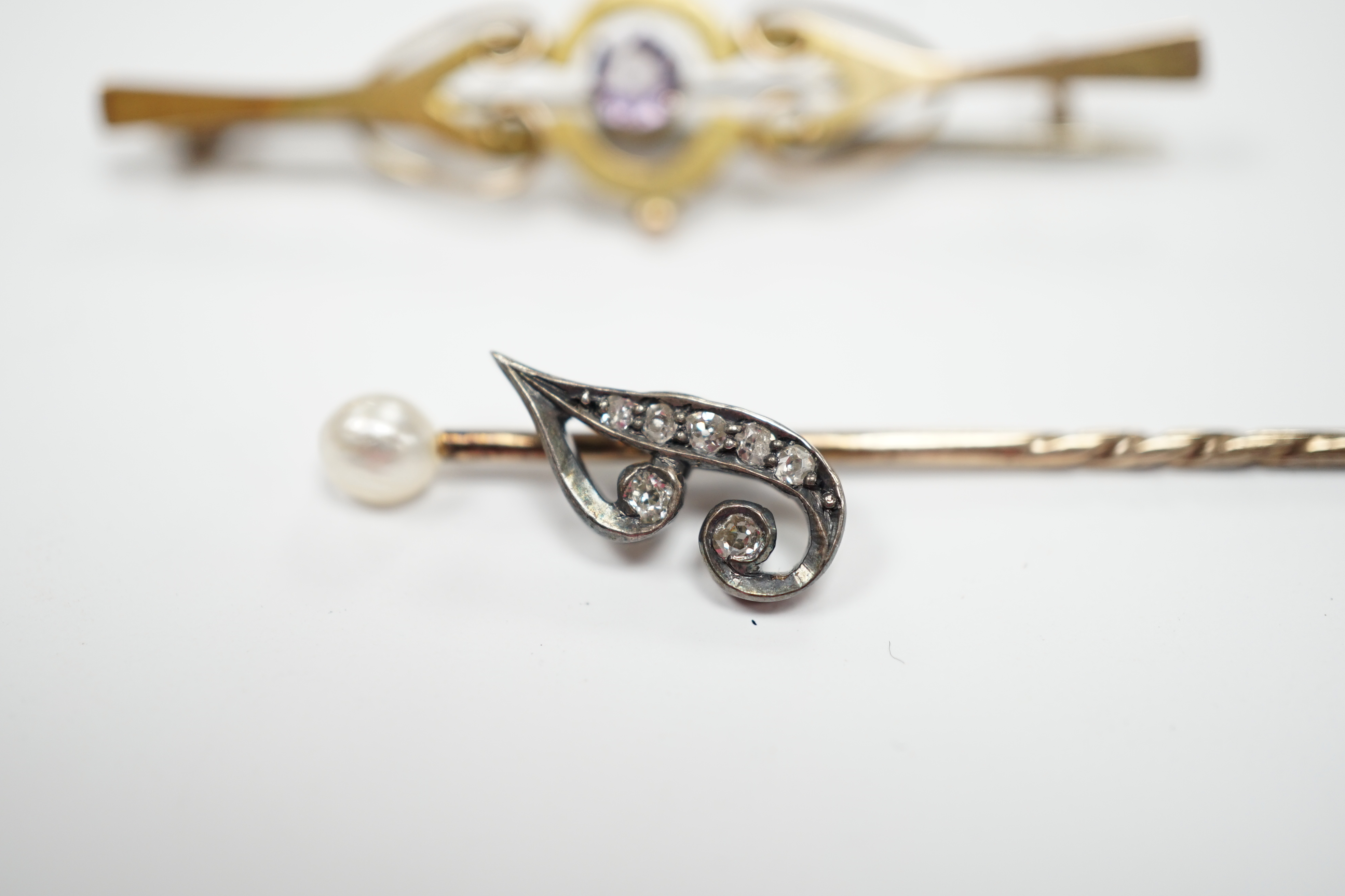 An early 20th century diamond chip and seed pearl set initial stick pin, 65mm and a 9ct and gem set brooch.
